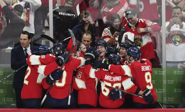 Florida Panthers players celebrate an empty net goal against the Edmonton Oilers during the third period in Game 6 of the NHL hockey Stanley Cup Final in Sunrise, Fla., Tuesday, June 17, 2025. (Nathan Denette/The Canadian Press via AP)