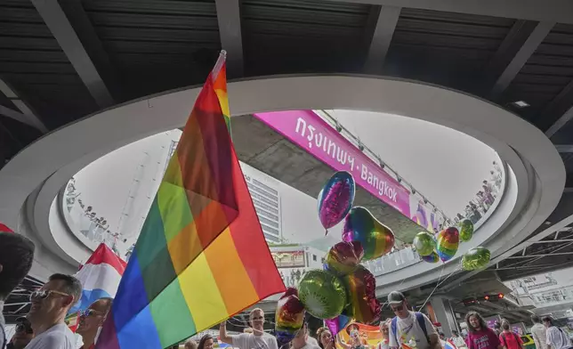 Participants hold a rainbow flag during the annual Pride Parade to celebrate the LGBTQ+ community’s Pride Month in Bangkok, Thailand, Sunday, June 1, 2025. (AP Photo/Sakchai Lalit)