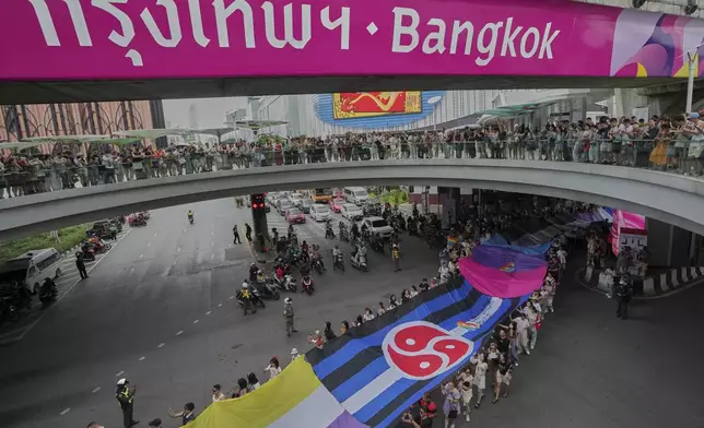 Participants hold a rainbow flag in the annual Pride Parade to celebrate the LGBTQ+ community’s Pride Month in Bangkok, Thailand, Sunday, June 1, 2025. (AP Photo/Sakchai Lalit)