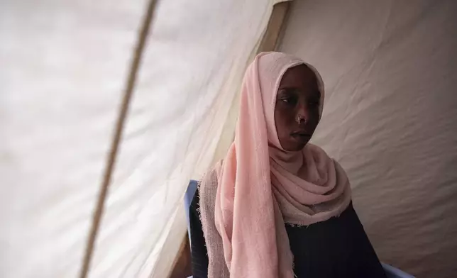 Zohal Abdullah Hamad, who was shot when gunfire broke out, poses for a photograph in Adre, Chad, Tuesday, May 6, 2025. (AP Photo/Caitlin Kelly)