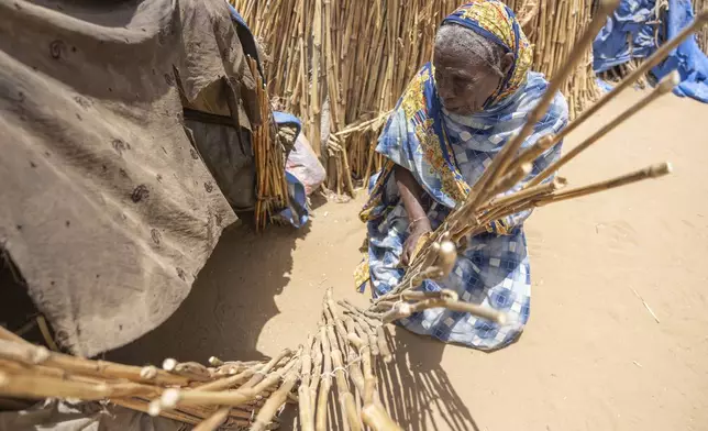 Fatima Omas Abdullah sits by her makeshift shelter in the Adre, Chad, transit camp, Friday, May 9, 2025. (AP Photo/Caitlin Kelly)