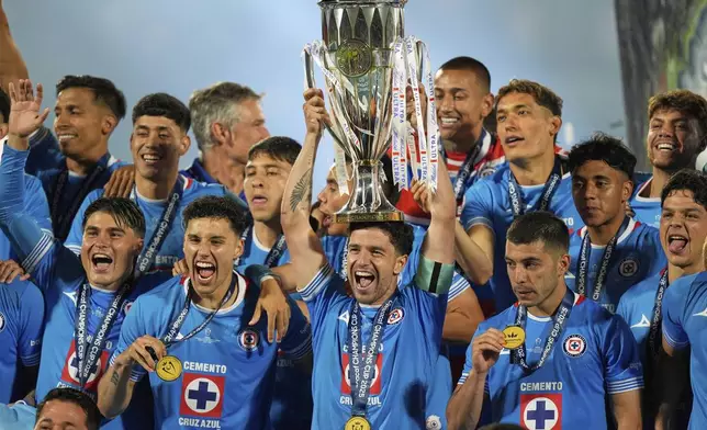 Ignacio Rivero of Mexico's Cruz Azul lifts the trophy after winning the CONCACAF Champions Cup final soccer match against Canada's Vancouver Whitecaps in Mexico City, Sunday, June 1, 2025. (AP Photo/Fernando Llano)