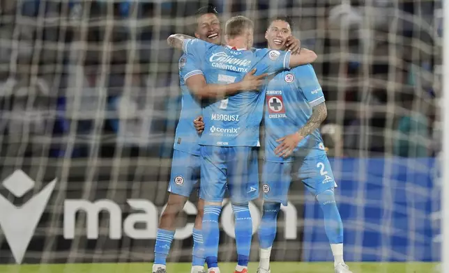 Angel Sepulveda of Mexico's Cruz Azul, left, is congratulated after scoring his side's 5th goal against Canada's Vancouver Whitecaps during the CONCACAF Champions Cup final soccer match in Mexico City, Sunday, June 1, 2025. (AP Photo/Fernando Llano)