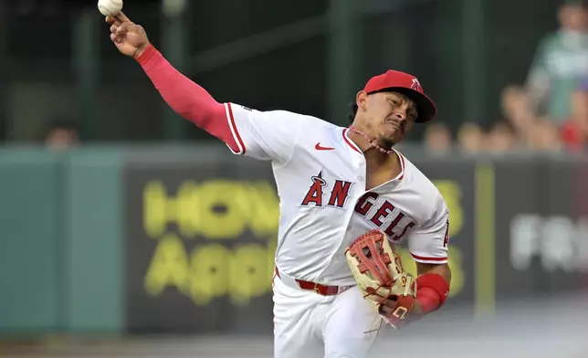 Los Angeles Angels first baseman LaMonte Wade Jr. makes a throw to home off a sacrifice fly by Boston Red Sox's Nate Eaton in the third inning of a baseball game Tuesday, June 24, 2025, in Anaheim, Calif. (AP Photo/Jayne Kamin-Oncea)