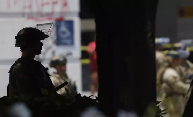 National Guard members stage near the Metropolitan Detention Center monitoring protests on Thursday, June 12, 2025, in Los Angeles (AP Photo/Etienne Laurent)
