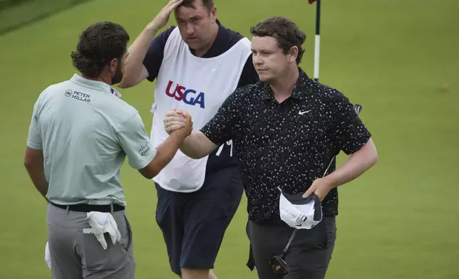 Robert MacIntyre, of Scotland, and Cameron Young, left, shake hands after finishing the final round of the U.S. Open golf tournament at Oakmont Country Club Sunday, June 15, 2025, in Oakmont, Pa. (AP Photo/Gene J. Puskar)