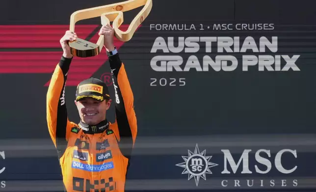 McLaren driver Lando Norris of Britain holds trophy after winning the Austrian Formula One Grand Prix in Spielberg, Austria, Sunday, June 29, 2025. (AP Photo/Darko Bandic)