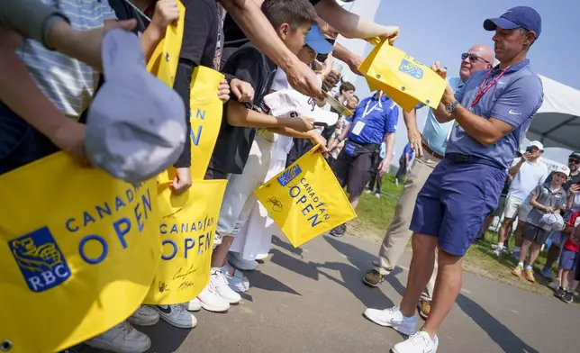 Rory McIlroy signs autographs for young fans during the pro-am at the Canadian Open Golf golf tournament, Wednesday, June 4, 2025, in Caledon, Ontario. (Peter Power/The Canadian Press via AP)