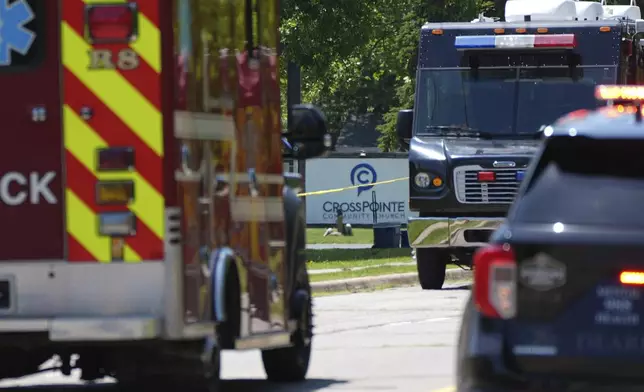 Emergency vehicles gather near CrossPointe Community Church in Wayne, Mich., Sunday, June 23, 2025. (AP Photo/Paul Sancya)