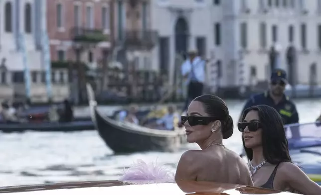 Khloé Kardashian, left, and Kim Kardashian leave a hotel ahead of the anticipated wedding celebrations of Jeff Bezos and Lauren Sanchez, in Venice, Italy, Friday, June 27, 2025. (AP Photo/Antonio Calanni)