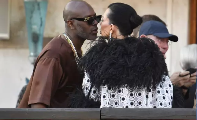 Corey Gamble, left, and Kriss Jenner leave a hotel during celebrations for Jeff Bezos and Lauren Sanchez Bezos' wedding, in Venice, Saturday, June 28, 2025. (AP Photo/Luigi Costantini)