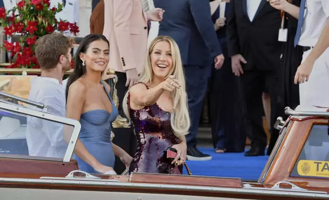 Ellie Goulding, right, leaves a hotel ahead of the anticipated wedding celebrations of Jeff Bezos and Lauren Sanchez, in Venice, Italy, Friday, June 27, 2025. (AP Photo/Luigi Costantini)