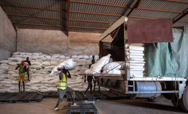 Workers load food aid onto a Fogbow truck as part of an aid program operated by retired American military officers at an airport in Juba, South Sudan, Monday, June 9, 2025. (AP Photo/ Florence Mettiaux)