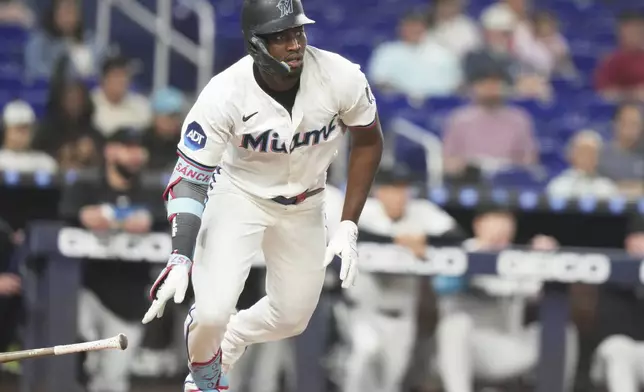 Miami Marlins' Jesus Sanchez drops his bat after hitting a RBI single to score Nick Fortes during the third inning of a baseball game against the Colorado Rockies, Tuesday, June 3, 2025, in Miami. (AP Photo/Lynne Sladky)