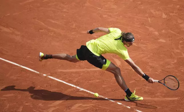 Germany's Alexander Zverev reaches for the ball as he plays Italy's Flavio Cobolli during their third round match of the French Tennis Open, at the Roland-Garros stadium, in Paris, Saturday, May 31, 2025. (AP Photo/Christophe Ena)