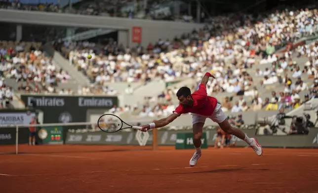 Serbia's Novak Djokovic plays a shot against Britain's Cameron Norrie during their fourth round match of the French Tennis Open at the Roland-Garros stadium in Paris, Monday, June 2, 2025. (AP Photo/Aurelien Morissard)