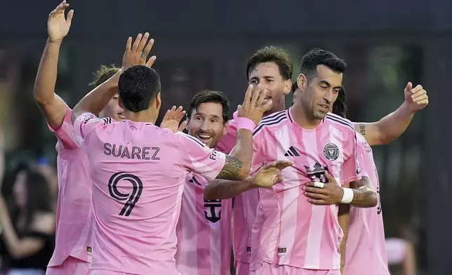 Teammates celebrate with Inter Miami forward Lionel Messi, center, after he scored the side's second goal against Columbus Crew during the first half of an MLS soccer match, Saturday, May 31, 2025, in Fort Lauderdale, Fla. (AP Photo/Rebecca Blackwell)