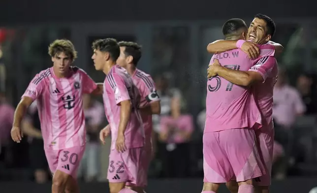 Inter Miami forward Luis Suarez, right, celebrates with teammates after scoring his side's fourth goal against Columbus Crew during the second half of an MLS soccer match, Saturday, May 31, 2025, in Fort Lauderdale, Fla. (AP Photo/Rebecca Blackwell)