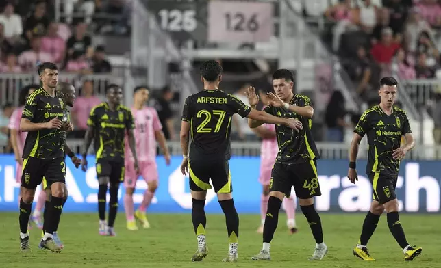 Columbus Crew defender Cesar Ruvalcaba (48) celebrates scoring his side's first goal against Inter Miami, with teammate forward Max Arfsten (27) during the second half of an MLS soccer match, Saturday, May 31, 2025, in Fort Lauderdale, Fla. (AP Photo/Rebecca Blackwell)