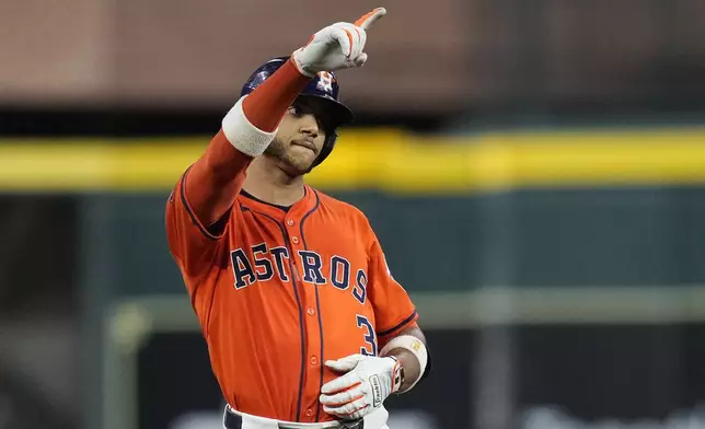 Houston Astros' Jeremy Peña celebrates after hitting a double during the third inning of a baseball game against the Minnesota Twins, Friday, June 13, 2025, in Houston. (AP Photo/Kevin M. Cox)