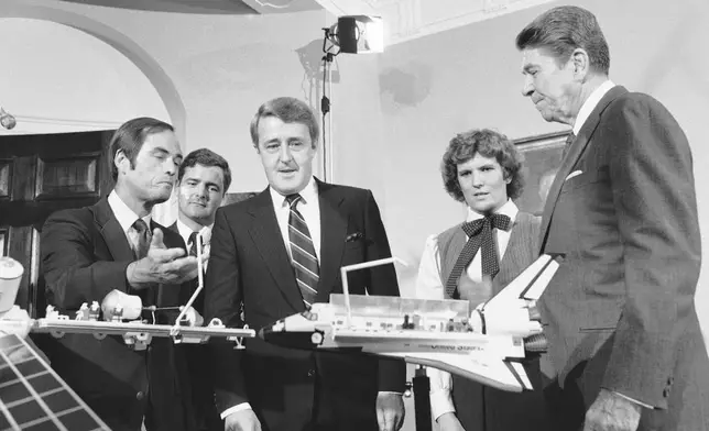 FILE - From left, mission commander Robert Crippen, Canadian astronaut Dr. Marc Garneau, Canadian Prime Minister Brian Mulroney and astronaut Kathy Sullivan meet with President Ronald Reagan in the White House in Washington on Sept. 25, 1984. (AP Photo/Barry Thumma, File)