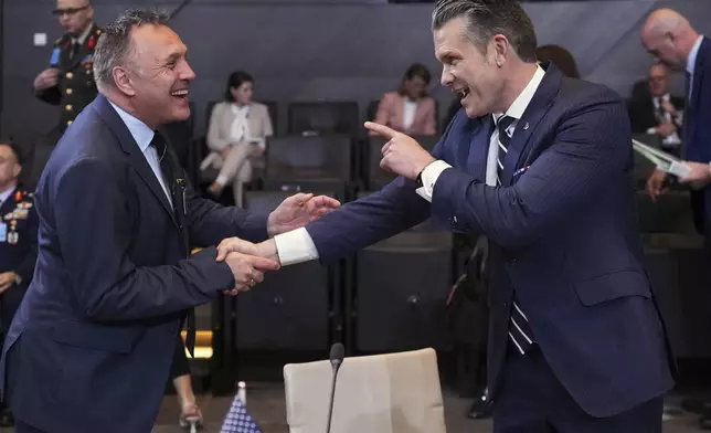 Defense Secretary Pete Hegseth, right, speaks with Norway's Defense Minister Tore Sandvik during a meeting of NATO defense ministers at NATO headquarters in Brussels, Thursday, June 5, 2025. (AP Photo/Virginia Mayo)