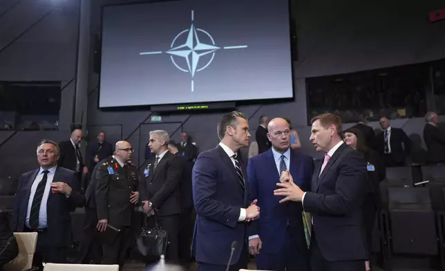 Defense Secretary Pete Hegseth, center, speaks with Estonia's Defense Minister Hanno Pevkur, right, during a meeting of NATO defense ministers at NATO headquarters in Brussels, Thursday, June 5, 2025. (AP Photo/Virginia Mayo)