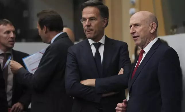 Britain's Defense Secretary John Healey, right, speaks with NATO Secretary General Mark Rutte, center, during a meeting of the Ukraine Defense Contact Group at the NATO headquarters in Brussels, Wednesday, June 4, 2025. (AP Photo/Virginia Mayo)
