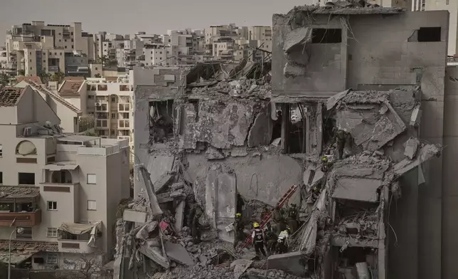 Israeli soldiers and rescue team work amid the rubble of residential buildings destroyed by an Iranian missile strike that killed several people, in Beersheba, Israel, on Tuesday, June 24, 2025. (AP Photo/Leo Correa)