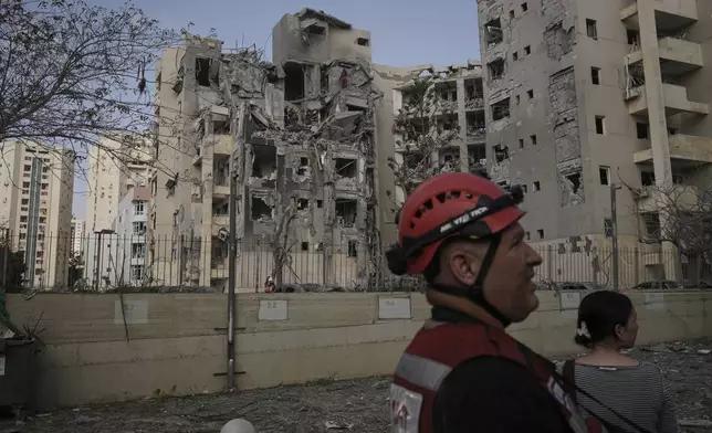 Israeli soldiers and rescue team search for survivors amid the rubble of residential buildings destroyed by an Iranian missile strike that killed several people, in Beersheba, Israel, on Tuesday, June 24, 2025. (AP Photo/Leo Correa)