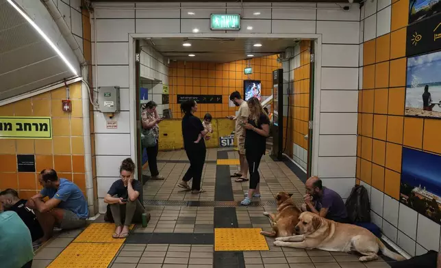 People take shelter in an underground metro station as air raid sirens warn of incoming Iranian strikes in Haifa, Israel, Tuesday, June 24, 2025. (AP Photo/Baz Ratner)