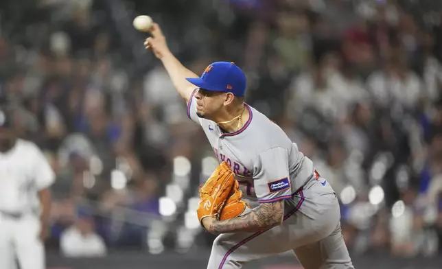 New York Mets relief pitcher José Buttó works against the Colorado Rockies in the eighth inning of a baseball game Saturday, June 7, 2025, in Denver. (AP Photo/David Zalubowski)