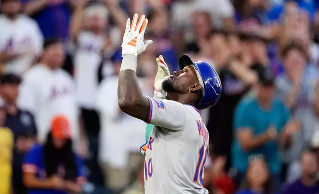 New York Mets' Ronny Mauricio gestures as he crosses home plate after hitting a solo home run off Colorado Rockies starting pitcher Germán Márquez in the third inning of a baseball game Saturday, June 7, 2025, in Denver. (AP Photo/David Zalubowski)