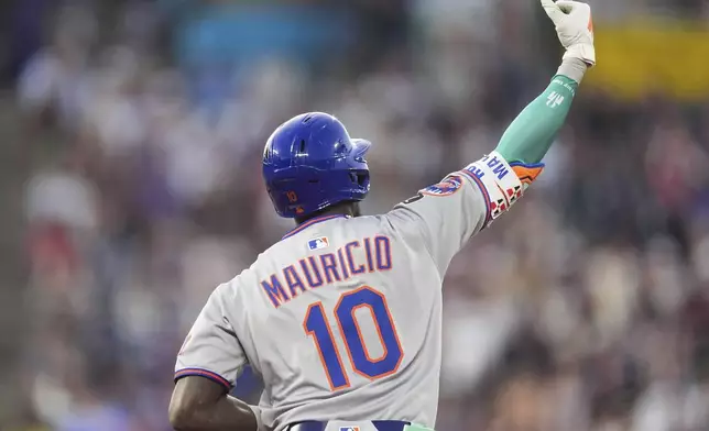 New York Mets' Ronny Mauricio gestures to the bullpen as he circles the bases after hitting a solo home run off Colorado Rockies starting pitcher Germán Márquez in the third inning of a baseball game Saturday, June 7, 2025, in Denver. (AP Photo/David Zalubowski)