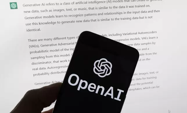 FILE - The OpenAI logo is seen on a mobile phone in front of a computer screen displaying output from ChatGPT, March 21, 2023, in Boston. (AP Photo/Michael Dwyer, File)
