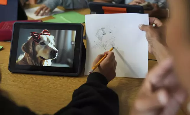 A student, left, talks with art teacher Lindsay Johnson about how to ask ChatGPT for help during a summer class at Roosevelt Middle School, Wednesday, June 25, 2025, in River Forest, Ill. (AP Photo/Nam Y. Huh)