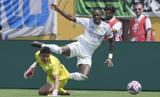 Pachuca's Carlos Moreno, bottom, and Real Madrid's Vinicius Junior battle for the ball during the Club World Cup Group H soccer match between Real Madrid and CF Pachuca in Charlotte, N.C., Sunday, June 22, 2025. (AP Photo/Chris Carlson)