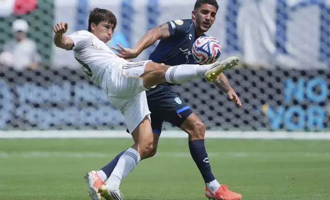 Real Madrid's Gonzalo Garcia, front, and Pachuca's Federico Pereira battle for the ball during the Club World Cup Group H soccer match between Real Madrid and CF Pachuca in Charlotte, N.C., Sunday, June 22, 2025. (AP Photo/Chris Carlson)