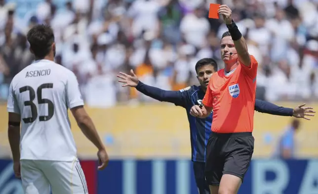 Referee Ramon Abatt shows a red card to Real Madrid's Raul Asencio during the Club World Cup Group H soccer match between Real Madrid and CF Pachuca in Charlotte, N.C., Sunday, June 22, 2025. (AP Photo/Chris Carlson)