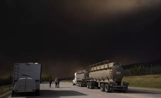 Wildfire smoke hangs in the air above Highway 97 north of Buckinghorse River, British Columbia, on Friday, May 30, 2025. (Nasuna Stuart-Ulin/The Canadian Press via AP)