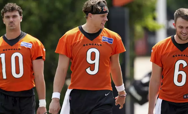 From left, Cincinnati Bengals' Payton Thorne (10), Joe Burrow (9) and Jake Browning (6) walk to the field before NFL football practice Tuesday, June 3, 2025, in Cincinnati. (AP Photo/Kareem Elgazzar)
