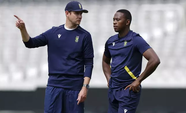 South Africa coach Stuart Broad speaks to Kagiso Rabada, right, during a nets session at Lord's, London, Monday June 9, 2025. (Ben Whitley/PA via AP)