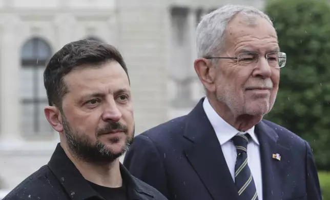 Ukraine's President Volodymyr Zelenskyy, left, and Austrian President Alexander van Der Bellen stand together in Vienna, Austria, Monday, June 16, 2025. (AP Photo/Heinz-Peter Bader)