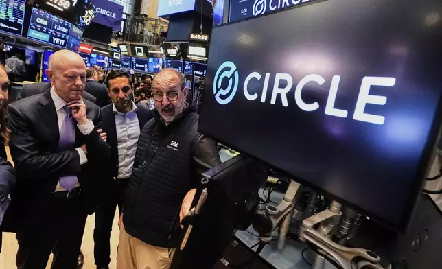 Jeremy Allaire, , left, Co-Founder, Chairman &amp; CEO of Circle, listens to specialist Peter Giacchi, right, before the IPO opens, on the floor of the New York Stock Exchange, Thursday, June 5, 2025. (AP Photo/Richard Drew)