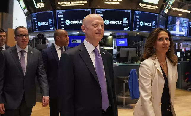 Jeremy Allaire, center, Co-Founder, Chairman &amp; CEO of Circle, escorted by NYSE President Lynn Martin, right, on the floor of the New York Stock Exchange, Thursday, June 5, 2025. (AP Photo/Richard Drew)