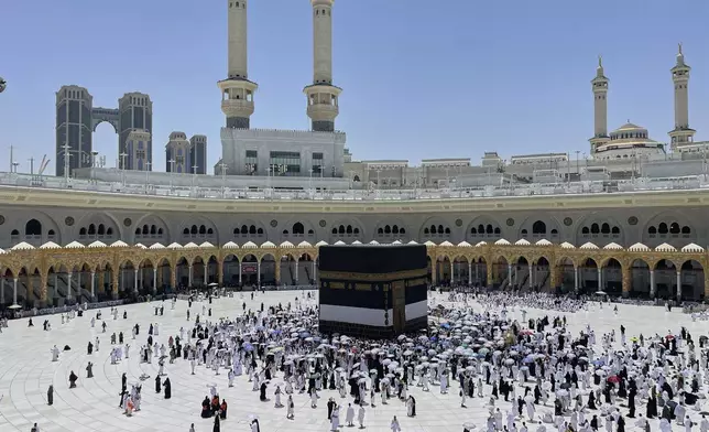 Muslim pilgrims walk around the Kaaba, the cubic building at the Grand Mosque, during the annual Hajj pilgrimage, in the Muslim holy city of Mecca, Saudi Arabia, Wednesday, June 4, 2025. (AP Photo/Amr Nabil)