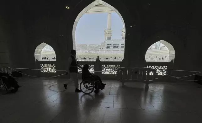 A Muslim pilgrim on a wheelchair in the Kaaba, the cubic building at the Grand Mosque, during the annual Hajj pilgrimage, in the Muslim holy city of Mecca, Saudi Arabia, Wednesday, June 4, 2025. (AP Photo/Amr Nabil)