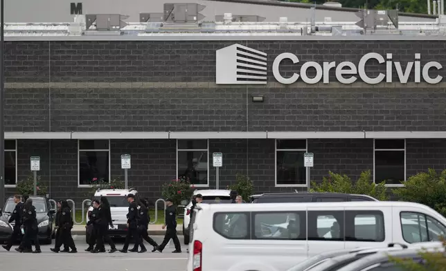 Prison personnel march into the Trousdale Turner Correctional Center, Monday, June 9, 2025, in Hartsville, Tenn. (AP Photo/George Walker IV)