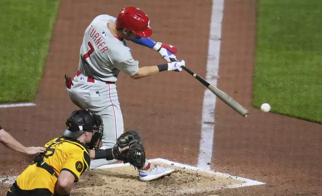 Philadelphia Phillies' Trea Turner (7) singles off Pittsburgh Pirates pitcher Chase Shugart, driving in two runs during the fourth inning of a baseball game in Pittsburgh, Friday, June 6, 2025. (AP Photo/Gene J. Puskar)