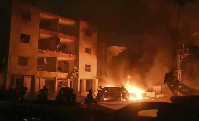 Firefighters work to extinguish a blaze after a missile launched from Iran struck Haifa, in northern Israel, on Sunday, June 15, 2025. (AP Photo/Rami Shlush)
